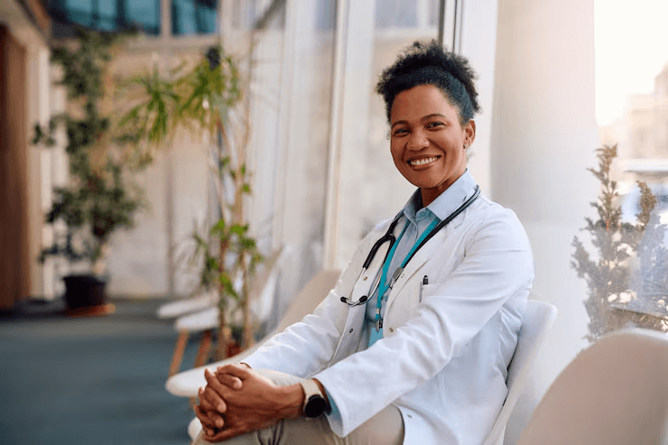 Dr. Tsion Tesfaye smiling in a white coat.