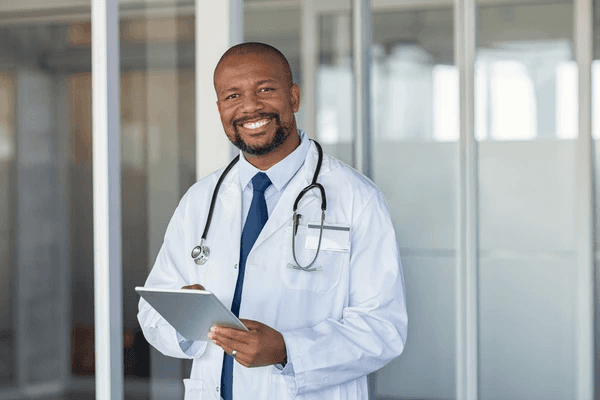 Dr. Yohannes Bekele smiling in a white coat.