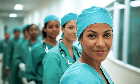 Medical staff standing together in blue surgical caps.